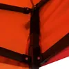 Close-up view of the corner joint and fabric of an orange tent. Voir les images du produit