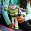 A child is holding a Buzz Lightyear action figure. Voir les images du produit
