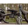 A close-up shot of a GoPro camera and a phone mount attached to a bicycle handlebar. Náhľad obrázku produktu