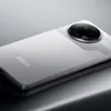 A close-up, angled shot of the back of a silver smartphone. Produktbild-Vorschau