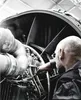 A mechanic is working on a jet engine. Anteprima dell’immagine prodotto