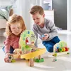 Two children playing with a wooden ball track toy in a room. Anteprima dell’immagine prodotto