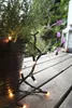 A potted lavender plant with string lights wrapped around it, sitting on a wooden deck. Produktbild-Vorschau