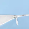 A close-up view of a zipper on a blue fabric product. Náhled obrázku produktu