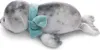 A plush toy seal lying on its side, wearing a blue scarf. Produktbild-Vorschau