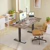 A home office setup with a standing desk, computer, and chair. Voir les images du produit