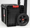 A close-up view of a black rolling tool cart with a red latch. Anteprima dell’immagine prodotto
