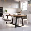 A modern kitchen and dining area with a wooden table and chairs. Anteprima dell’immagine prodotto