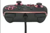 A black wired controller with red accents and lighting, connected to a cable. Voir les images du produit