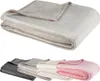 A folded blanket is shown in the top half of the image, and four folded blankets in different colors are shown in the bottom half. Produktbild-Vorschau