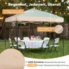 A pop-up canopy tent set up in a backyard with a table and chairs, suggesting outdoor use. Produktbild-Vorschau