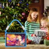 Two young girls are excitedly opening presents on Christmas morning, with a decorated Christmas tree in the background. A blue tablet with a colorful screen is in the foreground. Produktbild-Vorschau