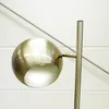A close-up of a brass lamp head and stem against a white and light gray background. Produktbild-Vorschau