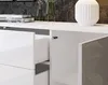 A close-up view of a white, high-gloss dresser with an open drawer and a partially open cabinet door. Anteprima dell’immagine prodotto