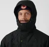 A close-up portrait of a man wearing a black hooded jacket and a navy blue beanie with a circular logo. Produktbild-Vorschau