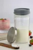 A glass jar with milk and a lid, next to some strawberries and blueberries. Náhľad obrázku produktu