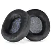 Two black ear pads with a purple geometric pattern inside, placed on a white background. Náhled obrázku produktu