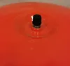 A close-up view of a black valve on an orange surface. Produktbild-Vorschau
