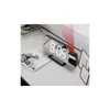 A digital alarm clock with a red projection beam is placed on a desk next to some books and framed pictures. Náhled obrázku produktu