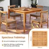 A wooden dining set on a tiled patio. Produktbild-Vorschau