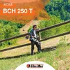 A man is using a string trimmer in a grassy, hilly area with trees and a wooden fence. Podgląd zdjęcia produktu
