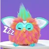 A fluffy toy with closed eyes and colorful fur, resting on a white surface against a purple background. The word 'Zzz' is overlaid on the left side of the image. Náhľad obrázku produktu