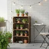 A balcony setting with plants on shelves and a small table. Náhled obrázku produktu