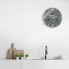 A modern kitchen scene with a clock on the wall and a sink area. Produktbild-Vorschau