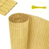 A rolled-up privacy screen made of bamboo-like material, with a separate piece of the unrolled screen and a bundle of yellow zip ties in the background. Produktbild-Vorschau