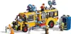 A LEGO set of a modified yellow school bus with various accessories and figures, set against a white background. Náhled obrázku produktu