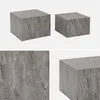 A collage of images showing two square coffee tables with a marble look in gray. Produktbild-Vorschau