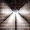 A solar-powered outdoor light mounted on a brick wall during a rain shower. Voir les images du produit