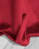 A close-up of a red curtain draped over a wooden floor. Produktbild-Vorschau