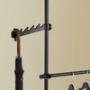 A close-up of a black coat rack with an umbrella hanging from it. Podgląd zdjęcia produktu