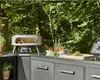 An outdoor kitchen setup with a pizza oven and ingredients. Produktbild-Vorschau
