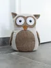 A stuffed owl doorstop sits on a tiled floor in front of a white door. Anteprima dell’immagine prodotto