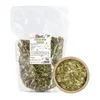 A bag of pumpkin seeds next to a bowl of pumpkin seeds. Voir les images du produit