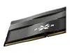 A close-up, angled view of a computer RAM module with a black heatsink and gold connectors. Podgląd zdjęcia produktu