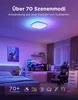 A bedroom with a bed, desk, and gaming chair, illuminated by colorful LED lights. Produktbild-Vorschau