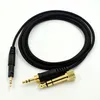 A black audio cable with gold connectors is laid out on a white background. Produktbild-Vorschau