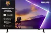 A Philips Ambilight TV with a scene of a knight on horseback at sunset displayed on the screen. Voir les images du produit