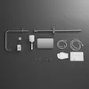 A flat lay of shower system components arranged on a dark gray surface. Podgląd zdjęcia produktu