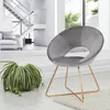 A modern living room with a grey velvet chair and a plant. Produktbild-Vorschau