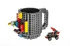 A LEGO-compatible brick mug with attached building blocks and a small toy vehicle. Anteprima dell’immagine prodotto