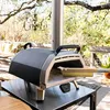 A pizza oven brush and scraper are shown resting inside a pizza oven on a patio. Produktbild-Vorschau