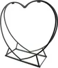 A black metal heart-shaped log holder on a white background. Produktbild-Vorschau