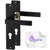 A pair of black door handles with a gold lock mechanism, shown against a white background. A small white cloth with a purple logo is in the bottom right corner. Produktbild-Vorschau
