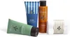 A set of men's grooming products including face wash, aftershave lotion, shower gel, and a washcloth, arranged on a white background. Produktbild-Vorschau