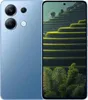 A blue smartphone is shown with its screen displaying a landscape image of terraced fields. Podgląd zdjęcia produktu