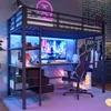 A loft bed with a desk and gaming setup, illuminated by LED lights. Náhled obrázku produktu